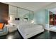 Cozy bedroom featuring a plush bed, side tables, and a mirrored wall reflecting a seating area at 4381 Flamingo Rd # 2612, Las Vegas, NV 89103