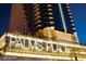 Exterior shot of the Palms Place building at night showcasing its modern design and illuminated signage at 4381 Flamingo Rd # 2612, Las Vegas, NV 89103