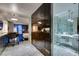 A modern interior featuring a marble floor, stainless steel kitchen, and a bathroom with glass shower and double vanity at 4381 Flamingo Rd # 2612, Las Vegas, NV 89103