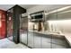 Modern kitchenette with stainless steel cabinets, appliances, and a minimalist design at 4381 Flamingo Rd # 2612, Las Vegas, NV 89103