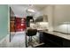 Compact kitchenette with stainless steel appliances and bar seating, adjacent to the bedroom area at 4381 Flamingo Rd # 2612, Las Vegas, NV 89103