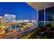 Cityscape view from the balcony, showing an outdoor seating area with modern railing and artificial grass at 4525 Dean Martin Dr # 2901, Las Vegas, NV 89103