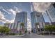 Low angle of modern high-rise condos with retail space, palm trees, and inviting landscaping at 4525 Dean Martin Dr # 2901, Las Vegas, NV 89103