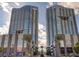 Stunning exterior view of two modern, high-rise towers with blue glass and palm trees at 4525 Dean Martin Dr # 2901, Las Vegas, NV 89103