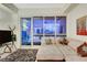 Cozy living room boasts comfortable sectional sofa, stylish rug, city views through large windows at 4525 Dean Martin Dr # 2901, Las Vegas, NV 89103