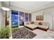 Bright living room featuring a sectional sofa, modern lighting, balcony with city view, and stylish decor at 4525 Dean Martin Dr # 2901, Las Vegas, NV 89103