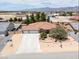 Aerial view of a well maintained single-story home with a three car garage, and desert landscaping at 4650 Stoneham St, Pahrump, NV 89061