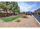 Spacious backyard features lush lawn, desert landscaping and a covered patio at 4650 Stoneham St, Pahrump, NV 89061