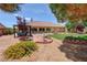 Picturesque backyard with desert landscaping, covered patio, and lush green lawn at 4650 Stoneham St, Pahrump, NV 89061