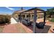 Beautiful backyard featuring a covered patio area with furniture and desert landscaping at 4650 Stoneham St, Pahrump, NV 89061