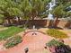 Beautiful backyard featuring lush landscaping, mature trees, and a charming fountain at 4650 Stoneham St, Pahrump, NV 89061