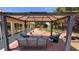 Charming backyard patio with gazebo, pavers, and comfortable blue outdoor furniture with a lush garden view at 4650 Stoneham St, Pahrump, NV 89061