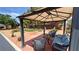 Landscaped backyard area with a covered patio offering comfortable seating and beautiful plantings at 4650 Stoneham St, Pahrump, NV 89061
