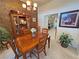 Intimate dining room with a wooden table, chairs, and cabinet, creating a cozy and inviting space for meals at 4650 Stoneham St, Pahrump, NV 89061