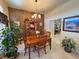Elegant dining room featuring a wooden table, chairs, and a view into the kitchen, great for entertaining guests at 4650 Stoneham St, Pahrump, NV 89061