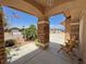 Inviting front porch with natural stone pillars and decorative seating at 4650 Stoneham St, Pahrump, NV 89061