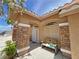Cozy covered porch with stone columns and a comfortable bench by the front door at 4650 Stoneham St, Pahrump, NV 89061