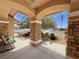 Inviting front porch with stone pillars and a relaxing bench at 4650 Stoneham St, Pahrump, NV 89061