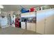 A section of garage with lots of organized shelves, cabinets, and a door to the outside at 4650 Stoneham St, Pahrump, NV 89061