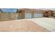 The property has a spacious three-car garage and an iron security gate at 4650 Stoneham St, Pahrump, NV 89061