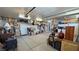 Spacious garage with overhead storage and a white door leading to the outside at 4650 Stoneham St, Pahrump, NV 89061