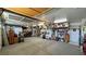 Spacious garage with overhead storage, shelving, and concrete floors at 4650 Stoneham St, Pahrump, NV 89061