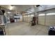 Large three car garage with white doors, storage, and plenty of open space at 4650 Stoneham St, Pahrump, NV 89061