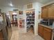 Kitchen view shows stainless refrigerator and well-stocked pantry for storage and easy access at 4650 Stoneham St, Pahrump, NV 89061