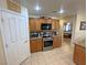 Kitchen showcases stainless appliances, wood cabinets and countertops, and an opening to the bedroom at 4650 Stoneham St, Pahrump, NV 89061