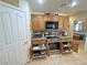 Kitchen boasts stainless appliances and wood cabinets with an open door revealing pull out drawers at 4650 Stoneham St, Pahrump, NV 89061