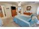 Comfortable bedroom with wooden dressers, ceiling fan, tv, carpeted floor and doorway to the bathroom at 4650 Stoneham St, Pahrump, NV 89061