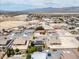 Expansive aerial shot of neighborhood with desert and mountain views in the distance at 4650 Stoneham St, Pahrump, NV 89061