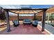 Relaxing patio with gazebo, pavers, and comfortable blue outdoor furniture, perfect for entertaining at 4650 Stoneham St, Pahrump, NV 89061