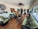 Inviting sun room with wood floors, ceiling fan, and large windows offering plenty of natural light at 4650 Stoneham St, Pahrump, NV 89061