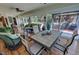 Bright sunroom with wood floors, wicker furniture, ceiling fans, and views of the landscaped backyard at 4650 Stoneham St, Pahrump, NV 89061