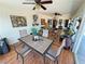 Bright sunroom with wood floors, wicker furniture, ceiling fans, and views of the landscaped backyard at 4650 Stoneham St, Pahrump, NV 89061