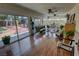 Bright sunroom with wood floors, wicker furniture, ceiling fans, and views of the landscaped backyard at 4650 Stoneham St, Pahrump, NV 89061