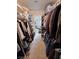 Loaded walk-in closet with organized clothes and access to the bathroom at 4650 Stoneham St, Pahrump, NV 89061