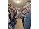 Organized walk-in closet with hanging clothes and shelving at 4650 Stoneham St, Pahrump, NV 89061
