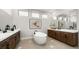 Luxurious bathroom featuring double vanities, a soaking tub, and elegant finishes at 490 Carter House Ave, Las Vegas, NV 89138