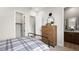 Cozy bedroom featuring a wooden dresser, walk-in closet, attached bathroom, and a comfortable bed at 490 Carter House Ave, Las Vegas, NV 89138