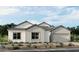 Charming single-story home featuring board and batten siding, a two-car garage, and well manicured landscaping at 490 Carter House Ave, Las Vegas, NV 89138