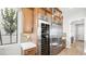 Gourmet kitchen features stainless steel appliances, wine cooler, and custom cabinetry at 490 Carter House Ave, Las Vegas, NV 89138