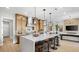 Open kitchen boasts stainless appliances, center island, and seamless flow to living area at 490 Carter House Ave, Las Vegas, NV 89138