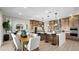 Spacious kitchen with stainless steel appliances, large island, and adjacent dining area at 490 Carter House Ave, Las Vegas, NV 89138