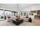 Open-concept living room with large sectional sofa and access to outdoor patio at 490 Carter House Ave, Las Vegas, NV 89138