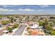 Aerial neighborhood view with colorful rooftops, tree-lined streets, and distant mountains at 4916 Carmichael Ave, Las Vegas, NV 89110