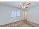 Comfortable bedroom with neutral carpet and a ceiling fan at 4916 Carmichael Ave, Las Vegas, NV 89110