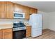 Kitchen features light countertops, stainless steel appliances, and wooden cabinetry at 4916 Carmichael Ave, Las Vegas, NV 89110