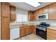 Updated kitchen with stainless steel appliances, wood cabinets, and a bright window at 4916 Carmichael Ave, Las Vegas, NV 89110